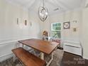 Cozy dining area featuring a rustic wood table and a stylish chandelier at 159 Autumn Mist Rd, Statesville, NC 28677