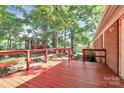 A large back deck outside a brick home, surrounded by trees and a storage shed at 16509 Kimbolten Dr, Huntersville, NC 28078