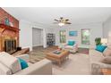 Bright living room with a brick fireplace and neutral decor, bathed in natural light at 16509 Kimbolten Dr, Huntersville, NC 28078