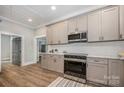 Spacious kitchen with stainless steel appliances, granite counters, and ample cabinet space at 201 Valley St, Stanley, NC 28164