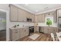Beautiful kitchen with stainless steel appliances, white subway tile backsplash and hardwood floors at 201 Valley St, Stanley, NC 28164