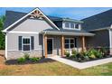 Inviting front porch with seating and tasteful landscaping offers a cozy welcome at 205 Spring Creek Dr, Mount Holly, NC 28120