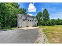 View of a charming two-story house with a two-car garage, showcasing the property's modern design and spacious lot at 237 Mariposa Rd, Stanley, NC 28164