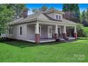 Inviting home with a covered front porch supported by classic columns and a well-maintained lawn at 2417 Statesville Blvd, Salisbury, NC 28147