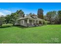 Charming single-Gathering home with a classic covered porch, complemented by a spacious and well-kept lawn at 2417 Statesville Blvd, Salisbury, NC 28147
