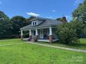 A charming single story home featuring a covered porch and a well maintained lawn at 2417 Statesville Blvd, Salisbury, NC 28147