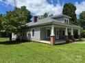 A charming single story home featuring a covered porch, brick pillars and a well maintained lawn at 2417 Statesville Blvd, Salisbury, NC 28147