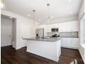 Beautiful white kitchen featuring stainless steel appliances, gray countertops, and a large kitchen island at 3001 Sadler Woods Ln, Charlotte, NC 28214