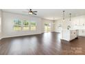 Open-concept living area featuring hardwood floors, plentiful windows, and sliding glass doors to the outside at 3005 Sadler Woods Ln, Charlotte, NC 28214