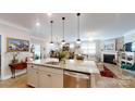 Bright, open-concept kitchen with island, pendant lighting, and views of the living and dining areas at 320 Secretariat Dr, Iron Station, NC 28080