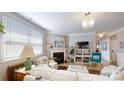 Cozy living room with a fireplace, natural light from a large window, and neutral decor at 320 Secretariat Dr, Iron Station, NC 28080