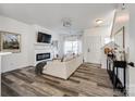 Open-concept living room with fireplace, wood floors, and modern decor at 325 Hancock Union Ln, Rock Hill, SC 29732