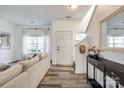 Bright living room with wood floors, a comfortable couch, and staircase at 325 Hancock Union Ln, Rock Hill, SC 29732