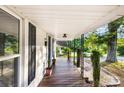 Charming front porch featuring black shutters, decorative plants, and wood flooring at 402 Ford St, Kannapolis, NC 28083