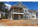 New construction home showcasing a covered front porch, large windows, and neutral gray siding at 4041 Grommet Ct, Matthews, NC 28105