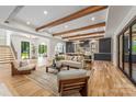 Spacious open-concept living area with wood beams, hardwood floors, and seamless flow to the kitchen at 412 Jefferson Dr, Charlotte, NC 28270