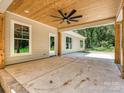 Expansive outdoor patio with tongue and groove ceiling, rustic wood supports, and fan providing a relaxing space at 501 E Cj Thomas Rd # 1, Monroe, NC 28110