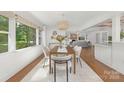 Bright dining room with hardwood floors and large window, perfect for entertaining at 5611 Robinhood Rd, Charlotte, NC 28211