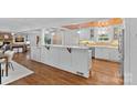 Modern kitchen featuring an open layout, white cabinetry, hardwood floors, and a kitchen island at 5611 Robinhood Rd, Charlotte, NC 28211