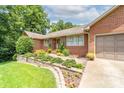 Charming single-story brick home with a well-manicured lawn and an inviting stone-lined walkway at 7029 Forest Hills Dr # 38, Denver, NC 28037