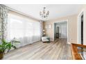 Bright living room with neutral walls, wood flooring, and a large window at 7029 Forest Hills Dr # 38, Denver, NC 28037