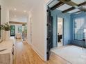 Hallway view showcasing hardwood floors, trim detail, and an office with an ensuite at 705 Mcalway Rd, Charlotte, NC 28211