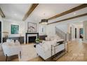 Bright, neutral living room featuring hard wood floors, a fireplace, and an open floor plan at 705 Mcalway Rd, Charlotte, NC 28211