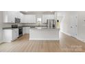 Modern kitchen features an island, stainless steel appliances, white cabinets, and granite counter tops at 7214 Jerimoth Dr, Charlotte, NC 28215