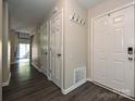 Inviting entryway with hardwood floors, coat hooks and easy access to the living areas at 7916 Charter Oak Ln, Charlotte, NC 28226