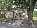 Charming brick townhome featuring a landscaped front yard and inviting entrance at 7916 Charter Oak Ln, Charlotte, NC 28226