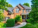 Beautiful brick home with large windows, well-maintained landscaping, and inviting entrance at 8102 Bergen Ct, Waxhaw, NC 28173