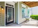 Inviting front entryway featuring a decorative door, sidelight windows, bench, and covered porch at 8312 Compton Acres Ln, Waxhaw, NC 28173