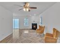 Bright living room featuring a fireplace, two yellow armchairs, and a sliding glass door at 11407 Lenswood Ct, Charlotte, NC 28214
