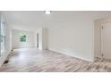 Spacious room with hardwood floors, white walls, and ample natural light at 1224 E Woodlawn Rd, Charlotte, NC 28209