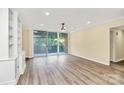 Bright and spacious living room featuring sliding glass doors to a balcony and built-in shelving at 1300 Queens Rd # 409, Charlotte, NC 28207