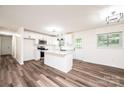 Updated kitchen featuring white cabinets, a center island, stainless steel appliances, and wood flooring at 1309 Poplar Cir, Newton, NC 28658