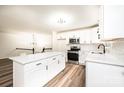 Bright kitchen with white cabinetry, stainless steel appliances, an island, and modern pendant lighting at 1309 Poplar Cir, Newton, NC 28658