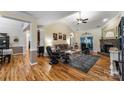 Spacious living room with hardwood floors, high ceilings, a stone fireplace, and plenty of natural light at 1622 Brookstone Dr, Hickory, NC 28602