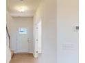 Bright entryway featuring hardwood floors, neutral walls, and a white front door with glass panes at 1821 Augustine St, Monroe, NC 28112