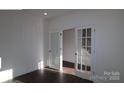 Bright office space featuring elegant french doors and dark hardwood floors at 1821 Augustine St, Monroe, NC 28112