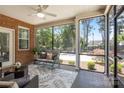 Cozy screened porch featuring comfortable seating, ceiling fan, and beautiful view at 2484 Early Richmond Ct, Denver, NC 28037