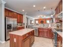 Well-equipped kitchen featuring stainless steel appliances, tile floors, and a center island at 3511 Dominion Green Dr, Charlotte, NC 28269