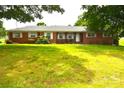 Traditional brick home with a spacious front yard and classic white-framed windows at 405 Wesley Heights Dr, Albemarle, NC 28001