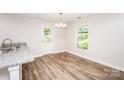 Eat in kitchen area featuring a granite countertops, hardwood floors, and natural light at 506 Broadway Ct, Statesville, NC 28677