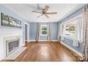 Living room featuring hardwood floors, a fireplace, and bright windows, perfect for entertaining and relaxation at 506 Gold St, Shelby, NC 28150