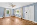 Bright living room with hardwood floors, ceiling fan, and large windows offering lots of natural light at 506 Gold St, Shelby, NC 28150
