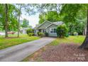 Exterior view of a home featuring a long driveway and beautifully maintained landscaping at 5424 Amado St, Charlotte, NC 28215