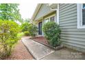 Inviting front porch and walkway bordered by lush greenery, leading to the home's entrance at 5424 Amado St, Charlotte, NC 28215