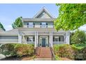 Charming two-story home featuring a welcoming front porch and manicured landscaping at 5728 Mantario Dr, Charlotte, NC 28269
