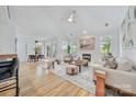 Bright, open living room with hardwood floors, fireplace, and views into dining area at 5728 Mantario Dr, Charlotte, NC 28269
